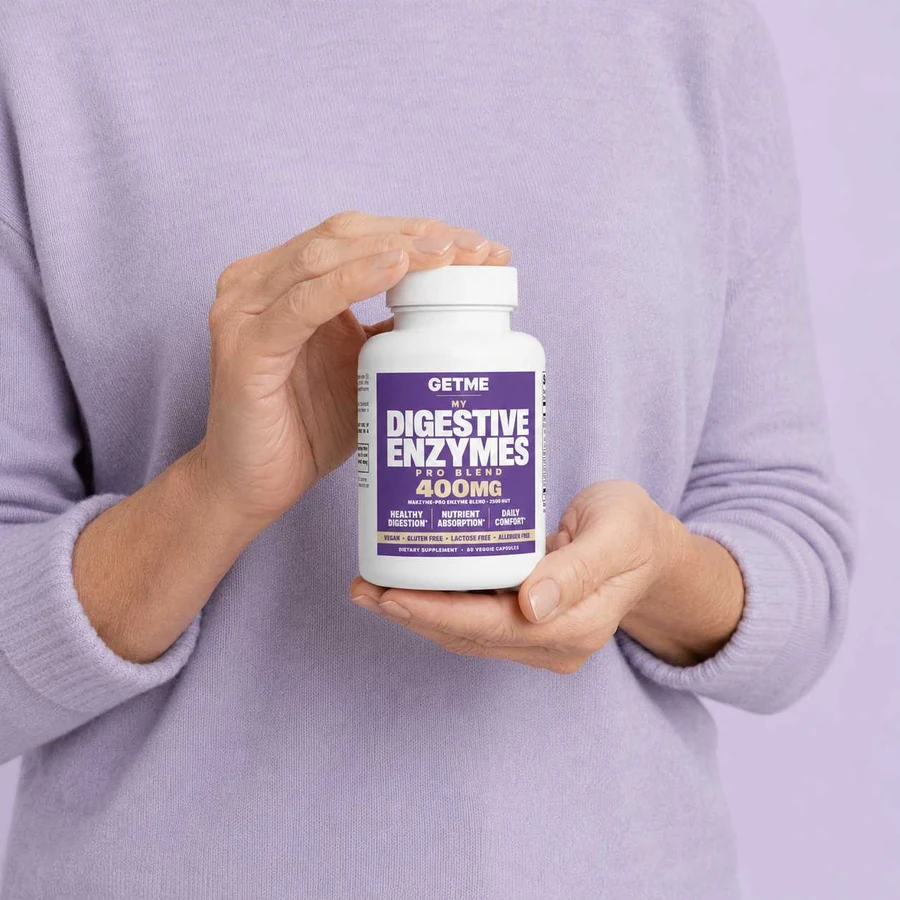 Woman holding a bottle of Getme Digestive Enzymes Pro Blend