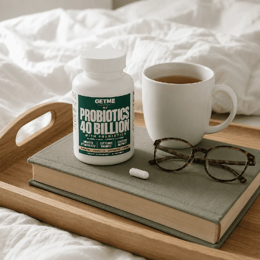 Getme Probiotics 40 Billion on a bed tray with a book and a cup of tea